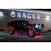 Close up of red double LED Oracle LED Illuminated Wheel Rings kit displayed on a parked jeep in front of a building