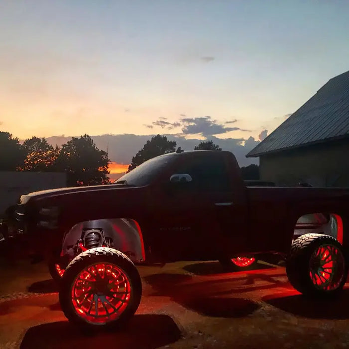 Black truck with red LED wheel rings kit Oracle Illumination product.