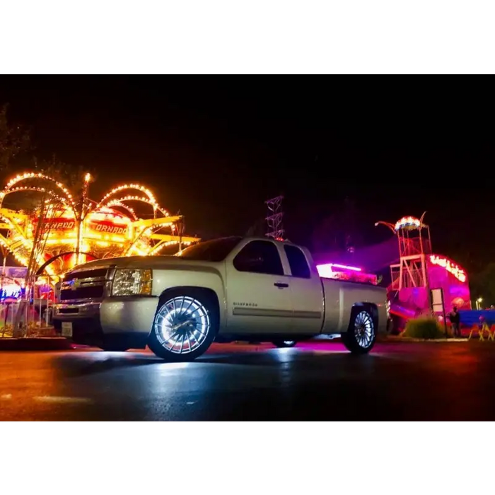 White LED wheel ring kit with truck parked by carnival