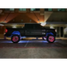 Black truck with red wheels parked in front of a building - Oracle LED Illuminated Wheel Rings