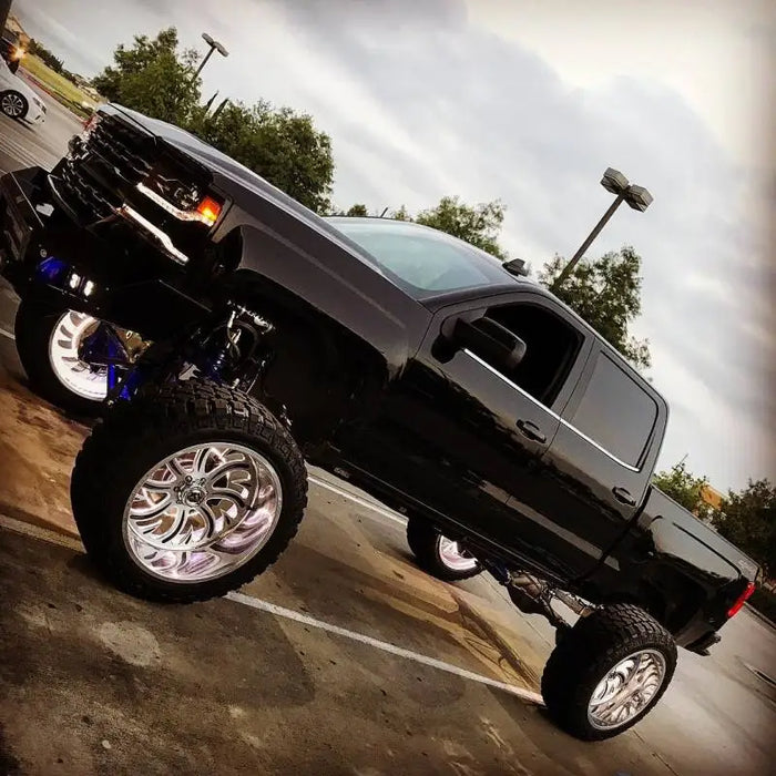 Black truck with chrome wheels and rims featuring Oracle LED Illuminated Wheel Rings - Double LED in White.