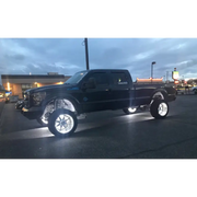 Black truck with a large tire fitted with Oracle LED Wheel Ring Kit - Double LED - White.