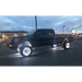 Black truck with a large tire fitted with Oracle LED Wheel Ring Kit - Double LED - White.