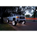 White LED illuminated wheel rings on truck parked on road - Oracle LED Wheel Ring Kit.