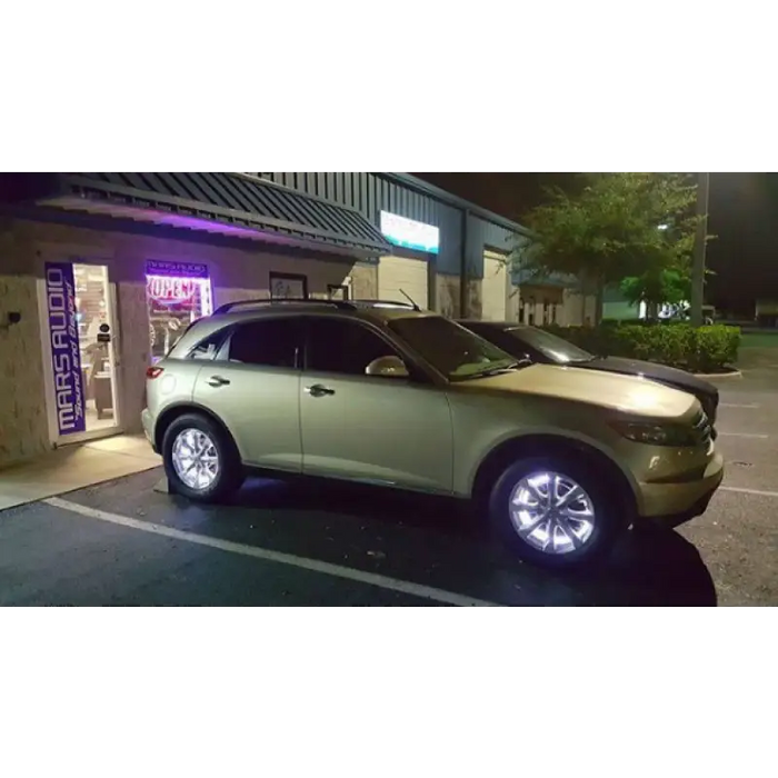 LED illuminated wheel rings kit with car parked in front of a building