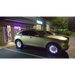 LED illuminated wheel rings kit with car parked in front of a building