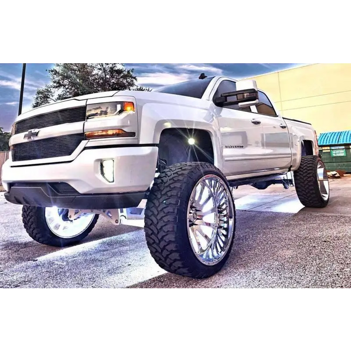 White truck with big tire featuring Oracle LED Illuminated Wheel Rings for Jeep Wrangler.