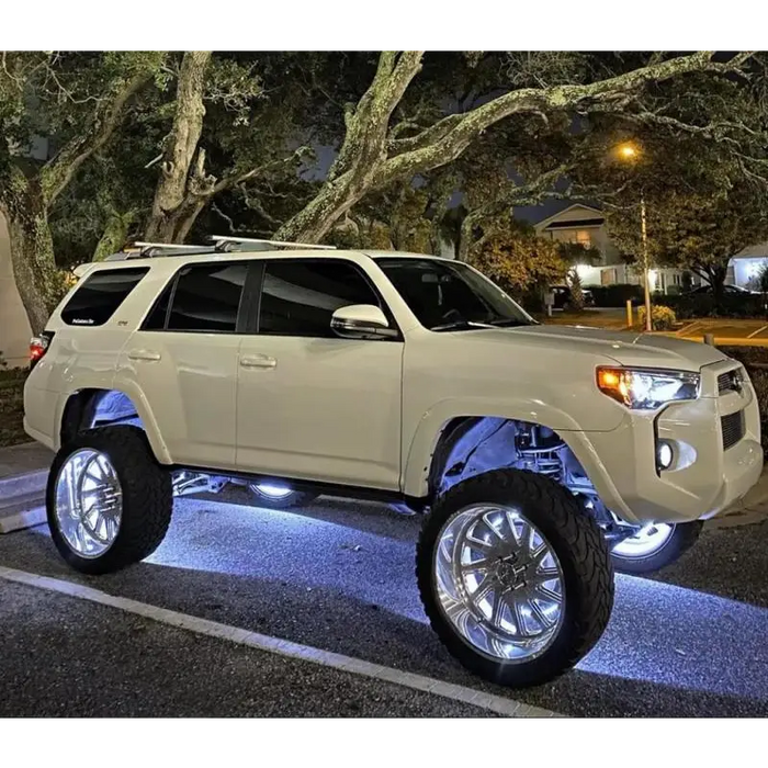 White LED illuminated wheel rings on a parked SUV.