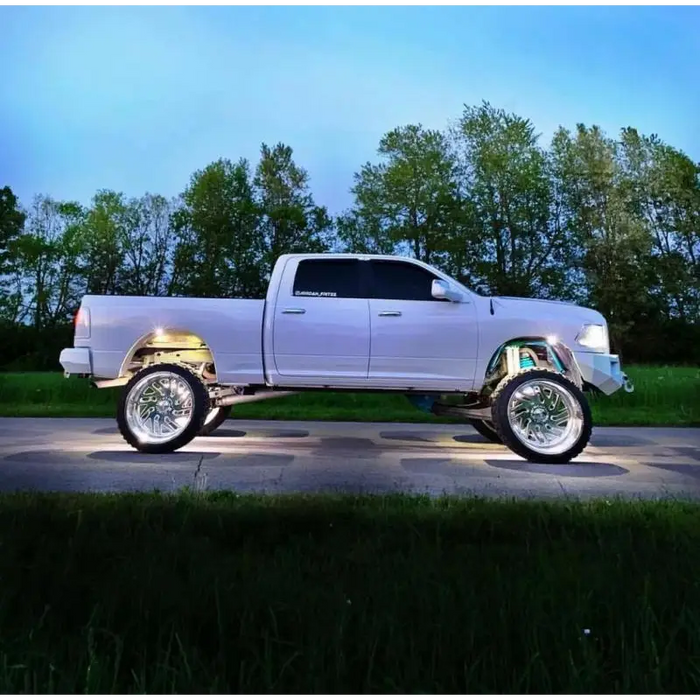 White truck parked on road featuring Oracle LED Illuminated Wheel Rings