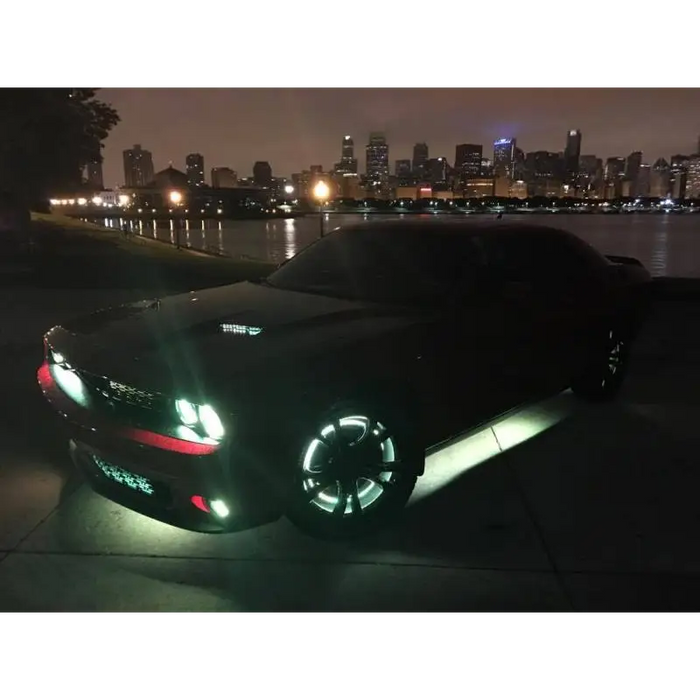 A car with green light on Oracle LED illuminated wheel rings.