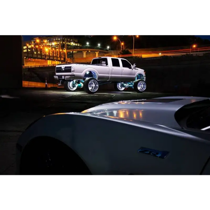 White LED Illuminated Wheel Rings on a truck in parking lot.