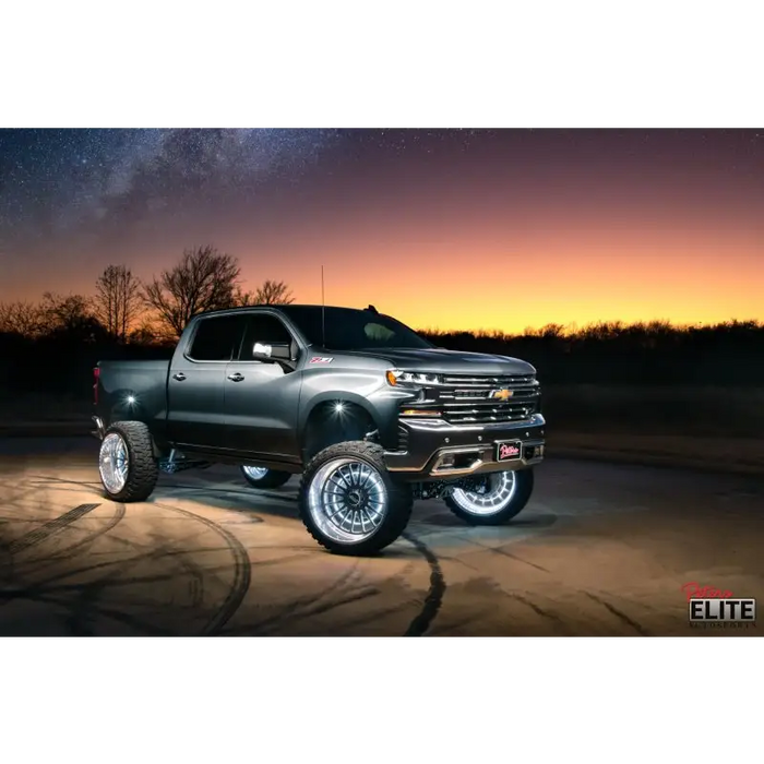 Truck parked in desert at night with LED illuminated wheel rings