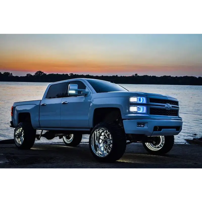 Oracle LED Illuminated Wheel Rings - White on blue truck parked on beach at sunset