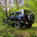 Black jeep parked in woods with Oracle Lighting 21-22 Ford Bronco flush style LED tail lights.