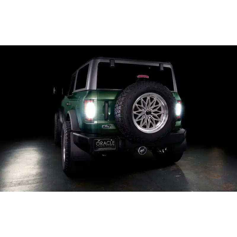 Green Jeep with black and white bumpers next to Oracle Lighting 21-22 Ford Bronco Flush Style LED Taillights.