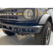 White Ford Bronco parked inside garage with ORACLE fog light kit installed