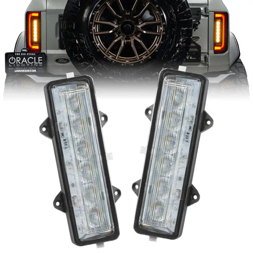 Pair of black LED headlights for Jeep by Oracle Lighting displayed in Ford Bronco Dual Function Reverse LED Modules Flush Tail Light.