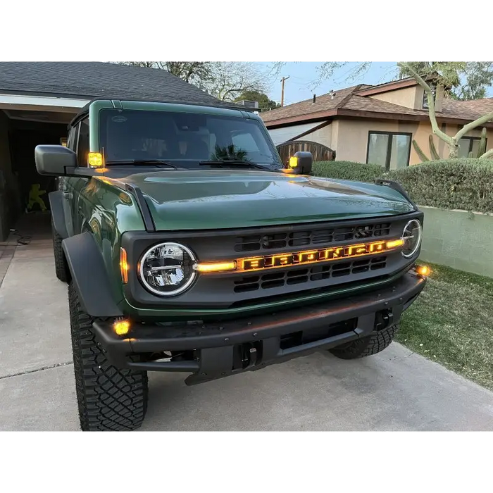 Green truck parked in front of house with ORACLE Lighting Universal Illuminated LED Letter Badges.