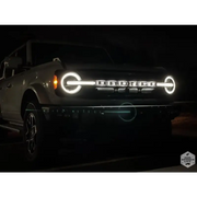 White truck with illuminated LED headlight from ORACLE Lighting Universal LED Letter Badges - Matte Black Surface Finish - B.