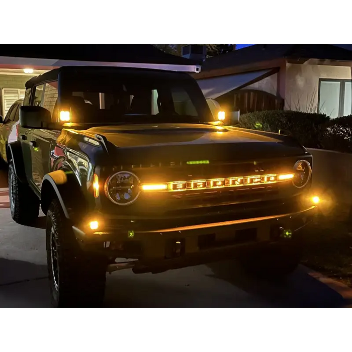 Truck parked in driveway with lights on showcasing LED letter badges