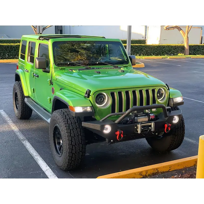 Green Jeep with Oracle Oculus Bi-LED Projector Headlights parked at yellow curb