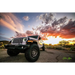 Oracle Oculus Bi-LED projector headlights for Jeep JL/Gladiator JT with sunset background