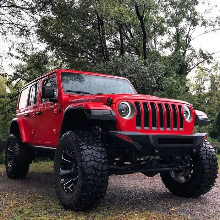 Red Jeep with Big Tires featuring Oracle Oculus Bi-LED Projector Headlights for Jeep JL/Gladiator JT