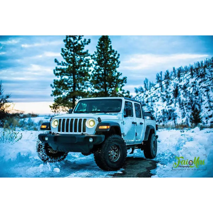 White Jeep parked in snow with Oracle Oculus Bi-LED Projector Headlights - Matte Black