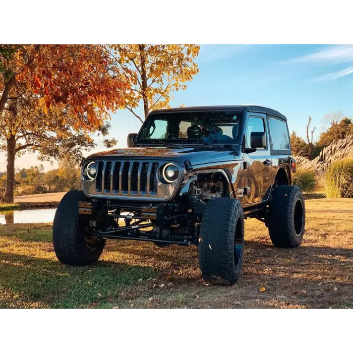 Jeep JL/Gladiator JT with Oracle Oculus Bi-LED projector headlights parked in field near tree.