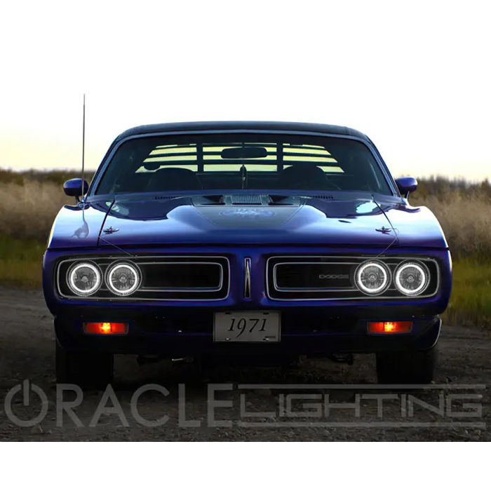 Blue Dodge Charger parked on dirt road with Oracle Pre-Installed Sealed Beam Halo Lights.