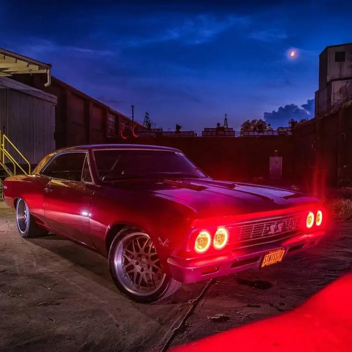 Red car parked in garage at night, displayed with Oracle Pre-Installed Lights 5.75 IN. Sealed Beam - ColorSHIFT Halo