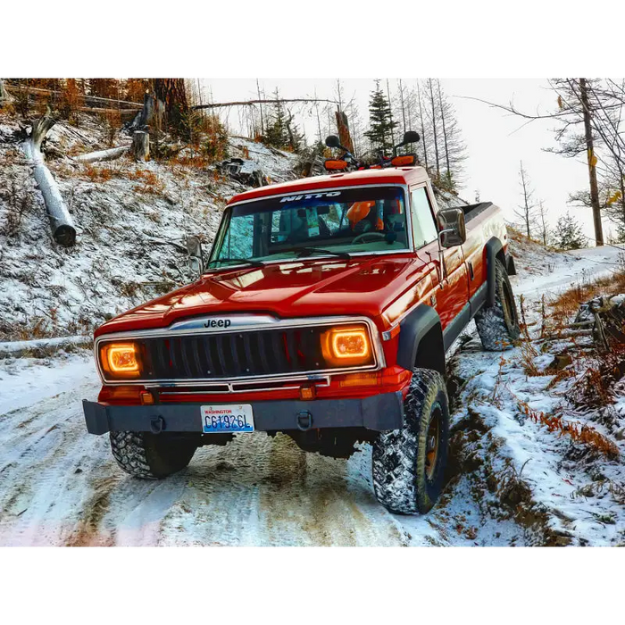 Red Jeep driving on snowy road with Oracle Pre-Installed Sealed Beam ColorSHIFT Halo.