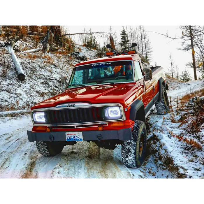 Red Jeep driving down snowy road with Oracle Pre-Installed Sealed Beam ColorSHIFT Halo