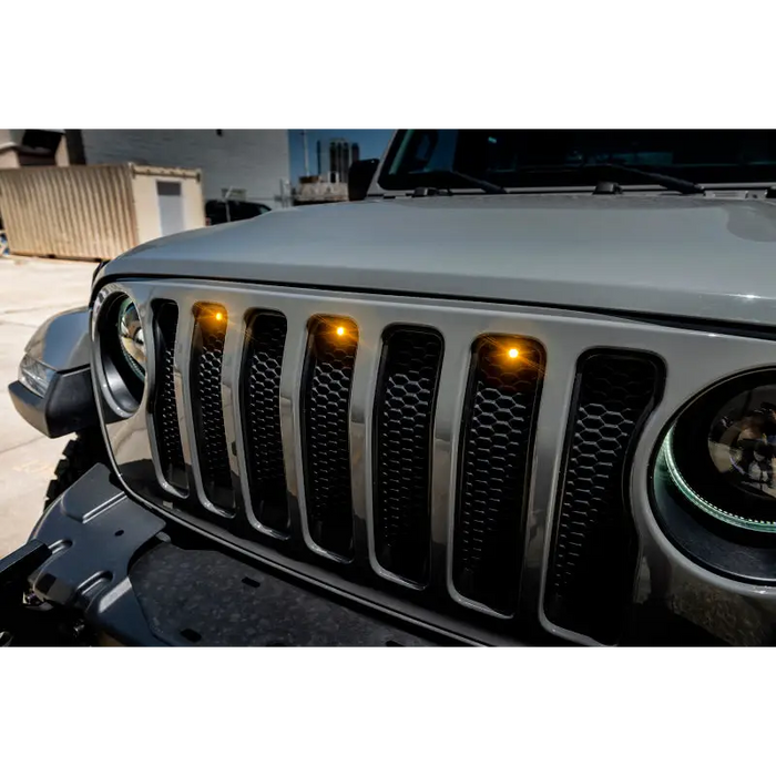 Oracle Pre-Runner Style LED Grille Kit for Jeep Wrangler JL - Amber, featuring a jeep with front bumper light