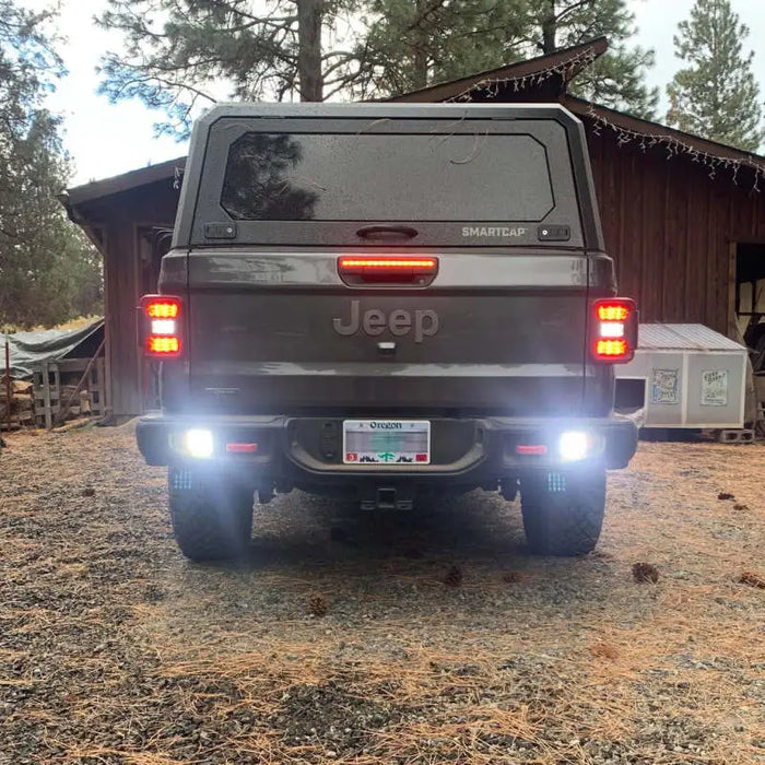 Jeep Gladiator JT with LED reverse lights parked in front of a barn