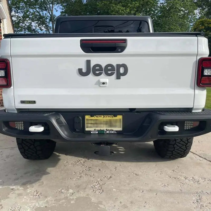 White truck rear end with black bumper, Oracle LED reverse lights for Jeep Gladiator JT.