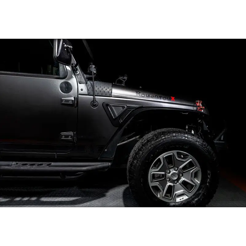 Black Jeep Wrangler JK parked in garage - Oracle Sidetrack LED System