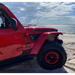 Oracle Sidetrack LED System for Jeep Wrangler JL/Gladiator JT parked on a beach.