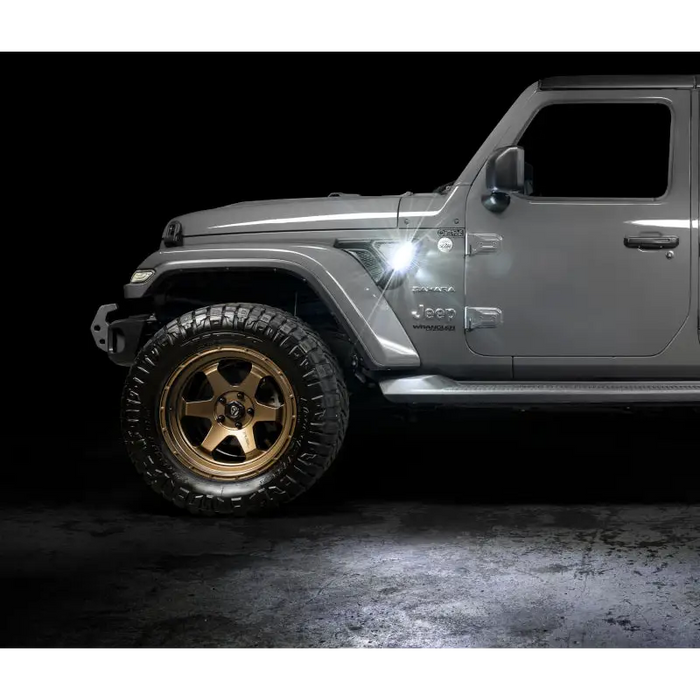 Oracle Sidetrack LED System for Jeep Wrangler JL/ Gladiator JT with white jeep and gold wheels against black background.