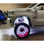 White truck with red wheels and rim illuminated by Oracle Underbody Wheel Well Rock Lights - White (4PCS) - 5000K