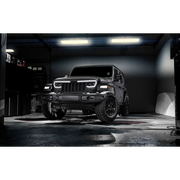 Jeep with black bumper and tire with Oracle white rock lights.