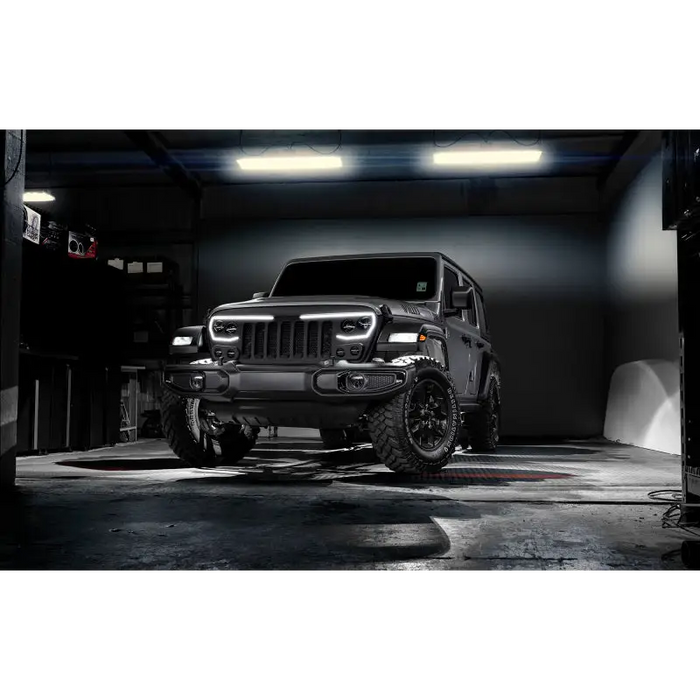 Jeep with black bumper and tire with Oracle white rock lights.