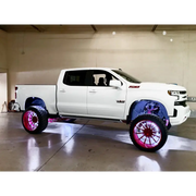 White rock lights for truck with pink wheels and black rims - Oracle Underbody Wheel Well Rock Light Kit.