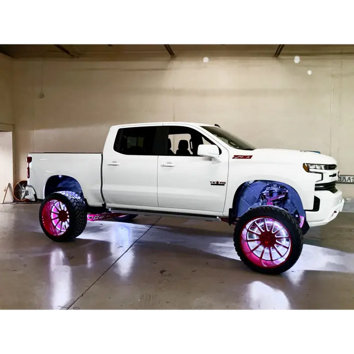 White rock lights for truck with pink wheels and black rims - Oracle Underbody Wheel Well Rock Light Kit.