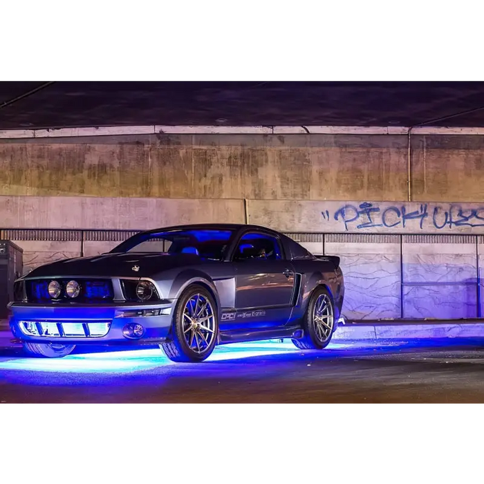 Dynamic colorshift car lights parked by graffiti wall