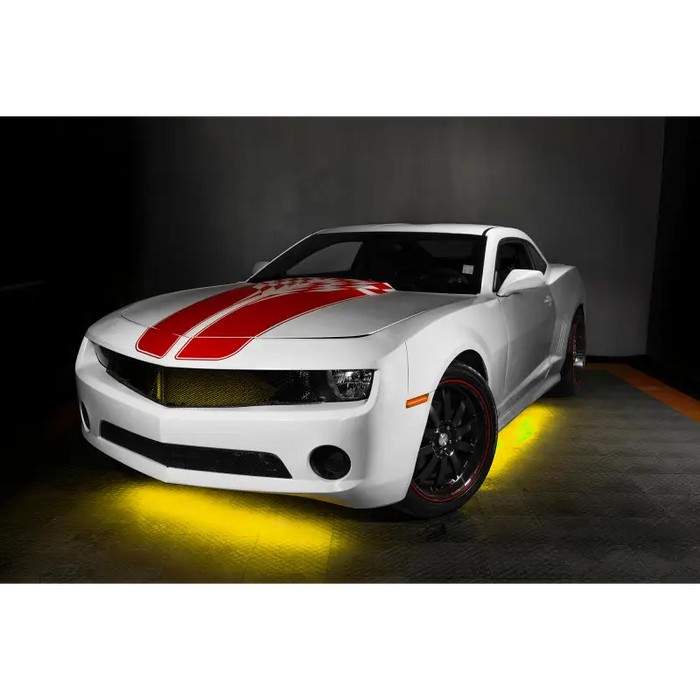 Dynamic ColorSHIFT LED Underbody Kit enhancing white car with red stripes on it.