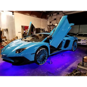 Blue Lamborghini with doors open, showcasing Oracle Universal LED Underbody Kit - ColorSHIFT for car lights.