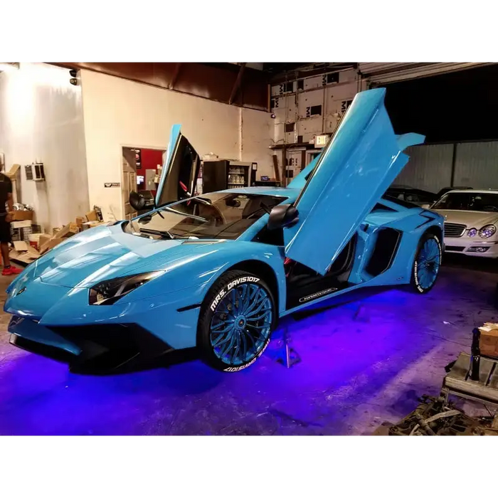 Blue Lamborghini with doors open, showcasing Oracle Universal LED Underbody Kit - ColorSHIFT for car lights.