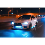 Oracle Universal LED Underbody Kit - ColorSHIFT enhances car lights on white vehicle driving at night.