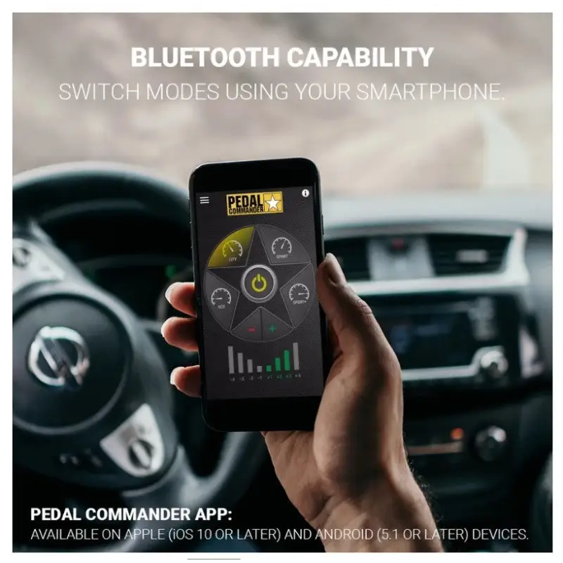 A person holding a phone with Pedal Commander Dodge/Jeep throttle controller.